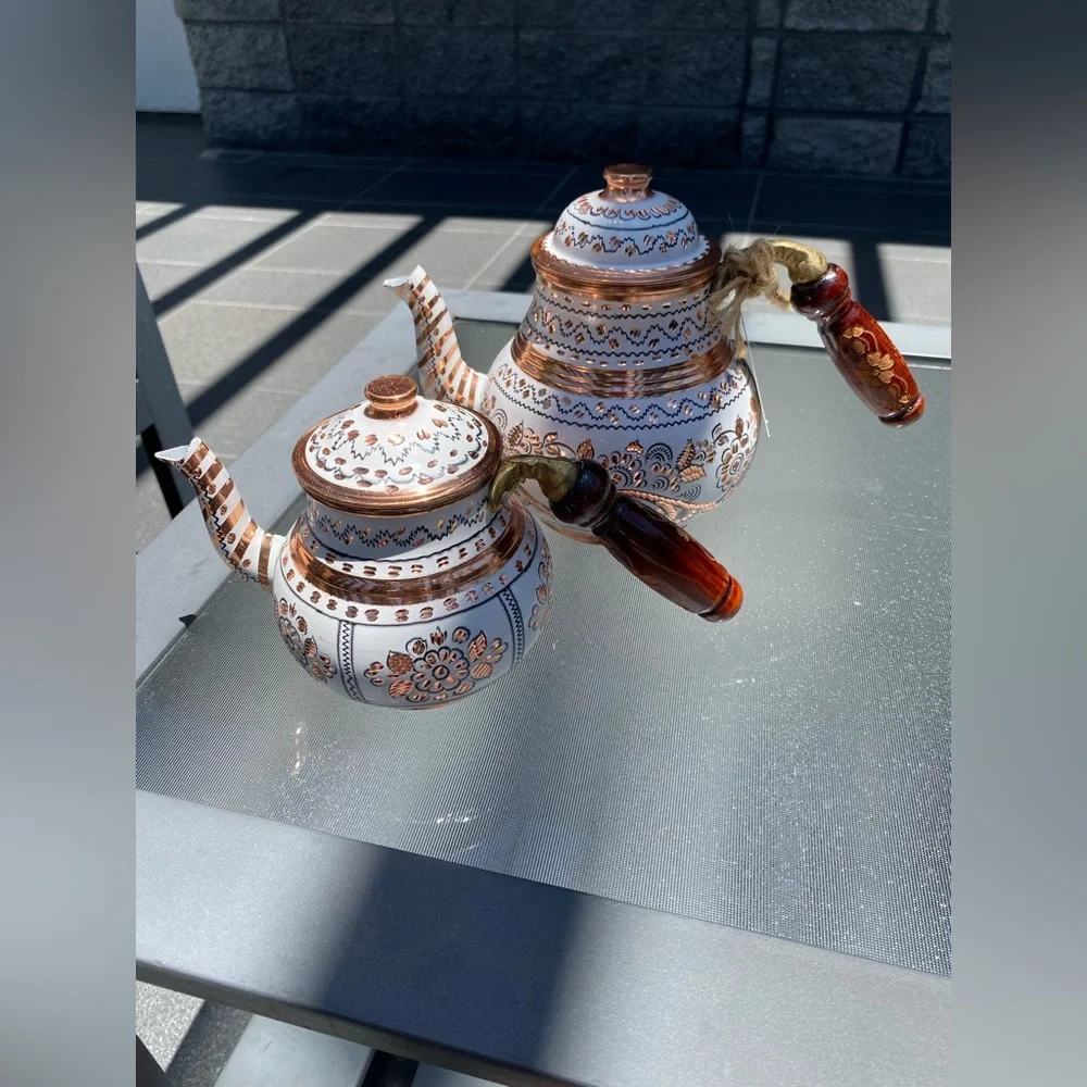This handmade, white-painted Turkish copper teapot set features traditional